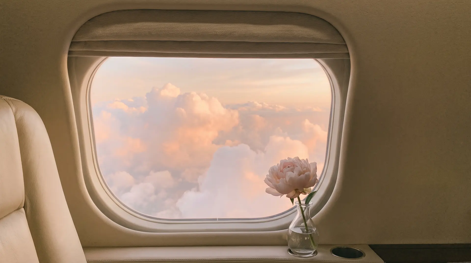 Pink clouds through an aircraft window